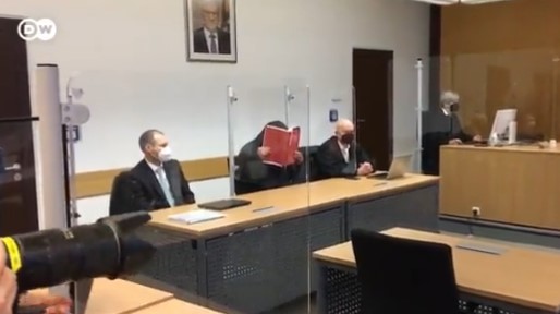 Турчинот со книга си го крие лицето да не гледа во вдовицата на Шаулиќ додека трае судењето за несреќата